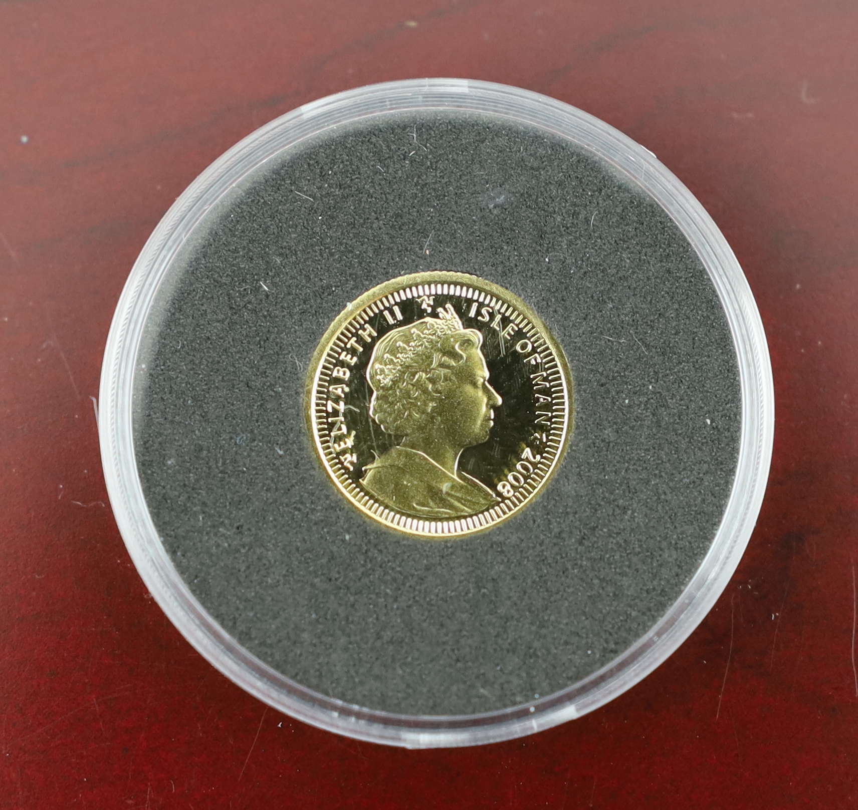 British Gold Coins, QEII 2000 1/4 sovereign of Britain and a 2008 25th anniversary 1/20th ounce gold angel coin, complete with certificates in a leather binder and a London mint office penny black 170th anniversary stamp